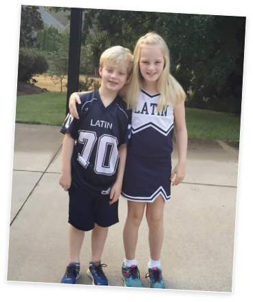Logan and Olivia as kids in Charlotte Latin jersey and cheerleading outfits